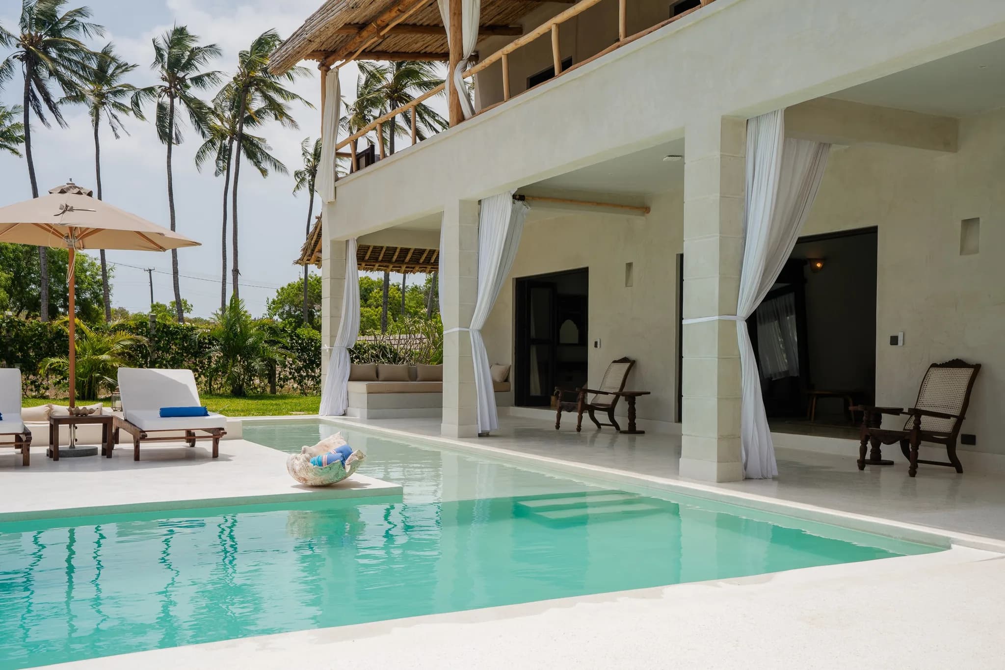 Multi-level tropical villa with private infinity pool and palm trees