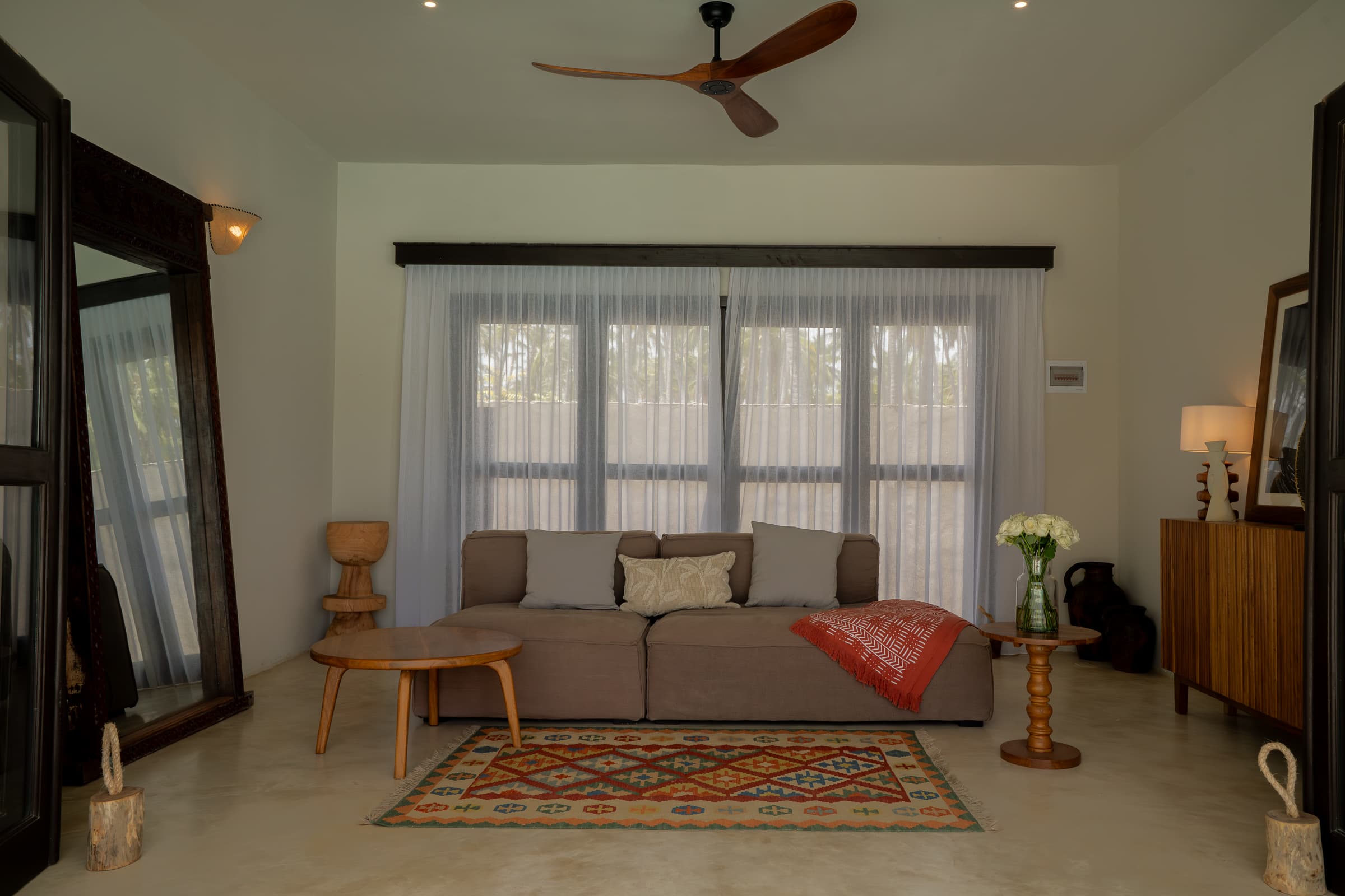 Bedroom suite with ceiling fan, open doors to garden and pool